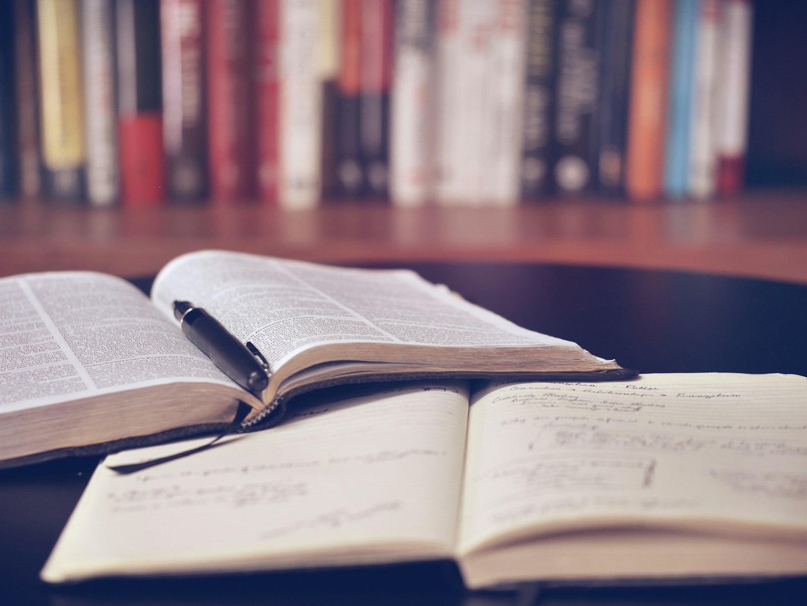 Open books and handwritten notes on a desk